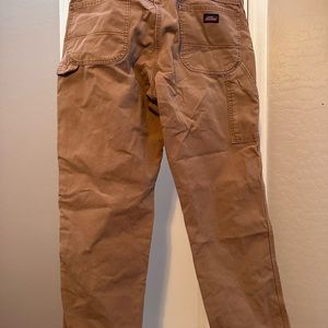 Dickies. brown cargo pants. slight fraying. on button hole